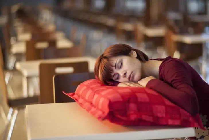 Woman with eyes closed experiencing deep REM sleep